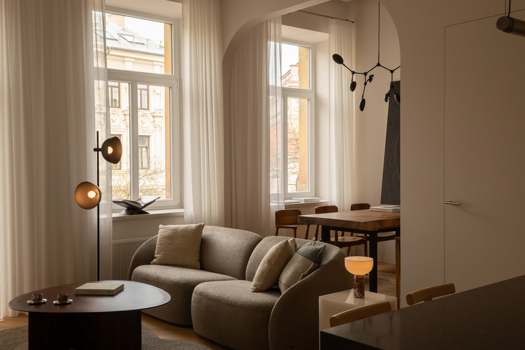 Drop chandelier in the background of a chic Milé Studio appartement 