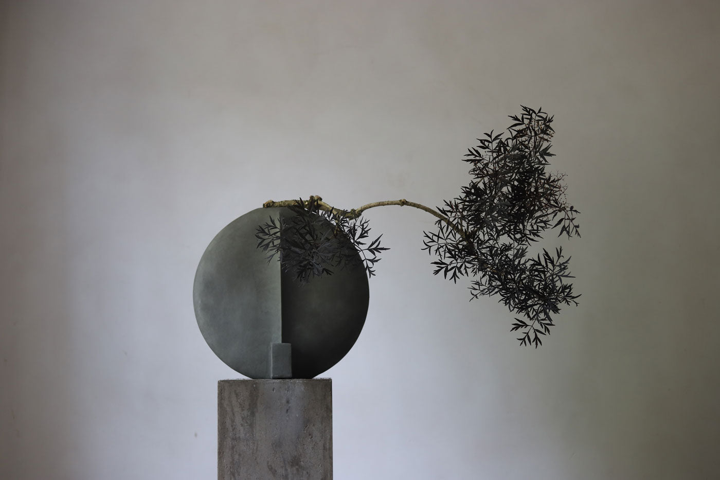 Guggenheim vase with botanical arrangement by Frida Kim