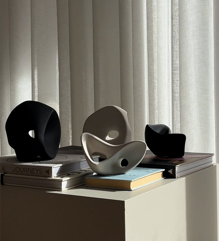 four Ori sculptures on books