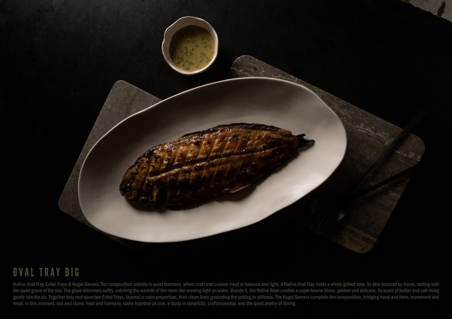 A Native Oval Tray holds a whole grilled sole, its skin bronzed by flame