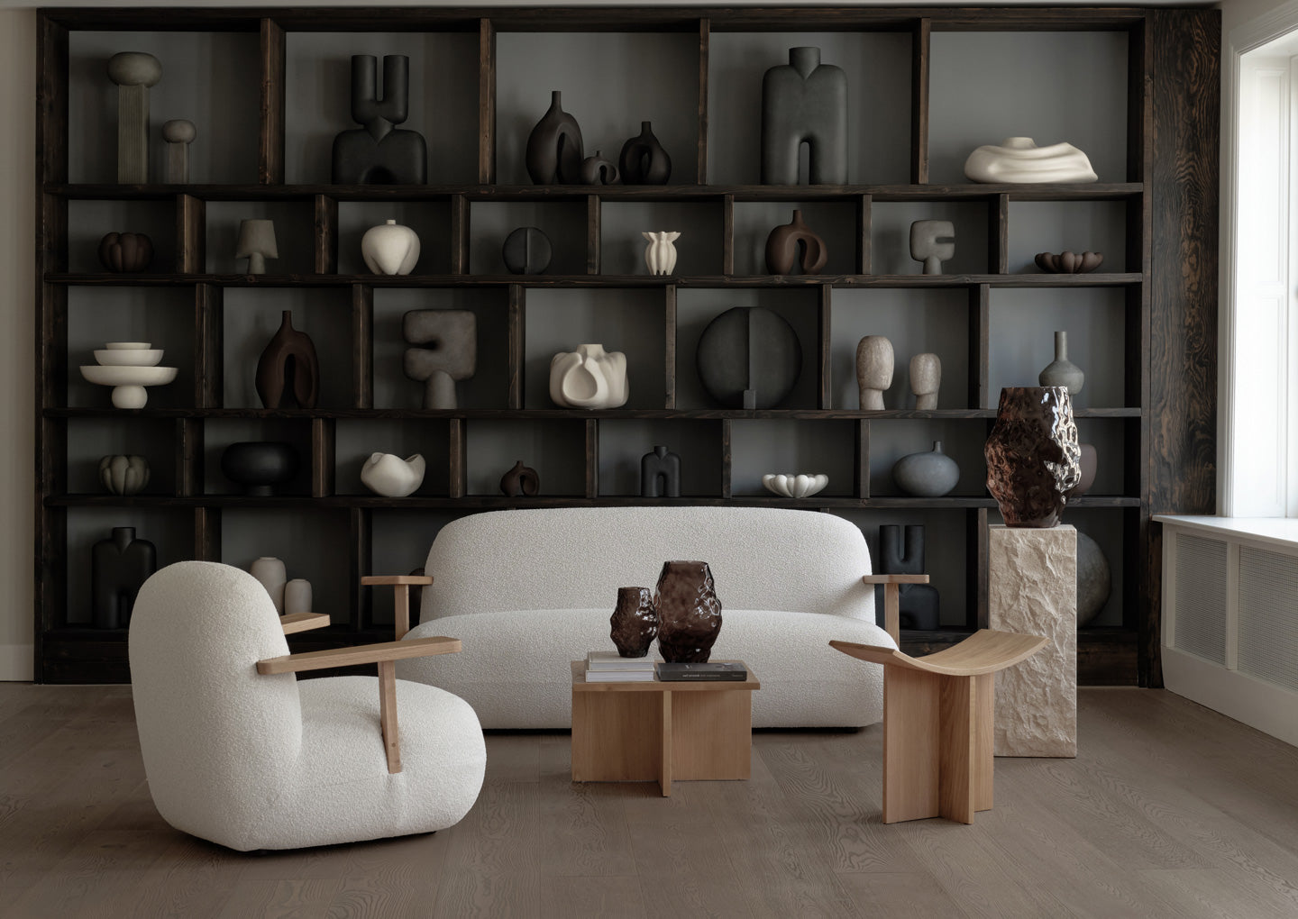 Toe lounge chair and sofa in front a shelves with 101 Copenhagen decorations  