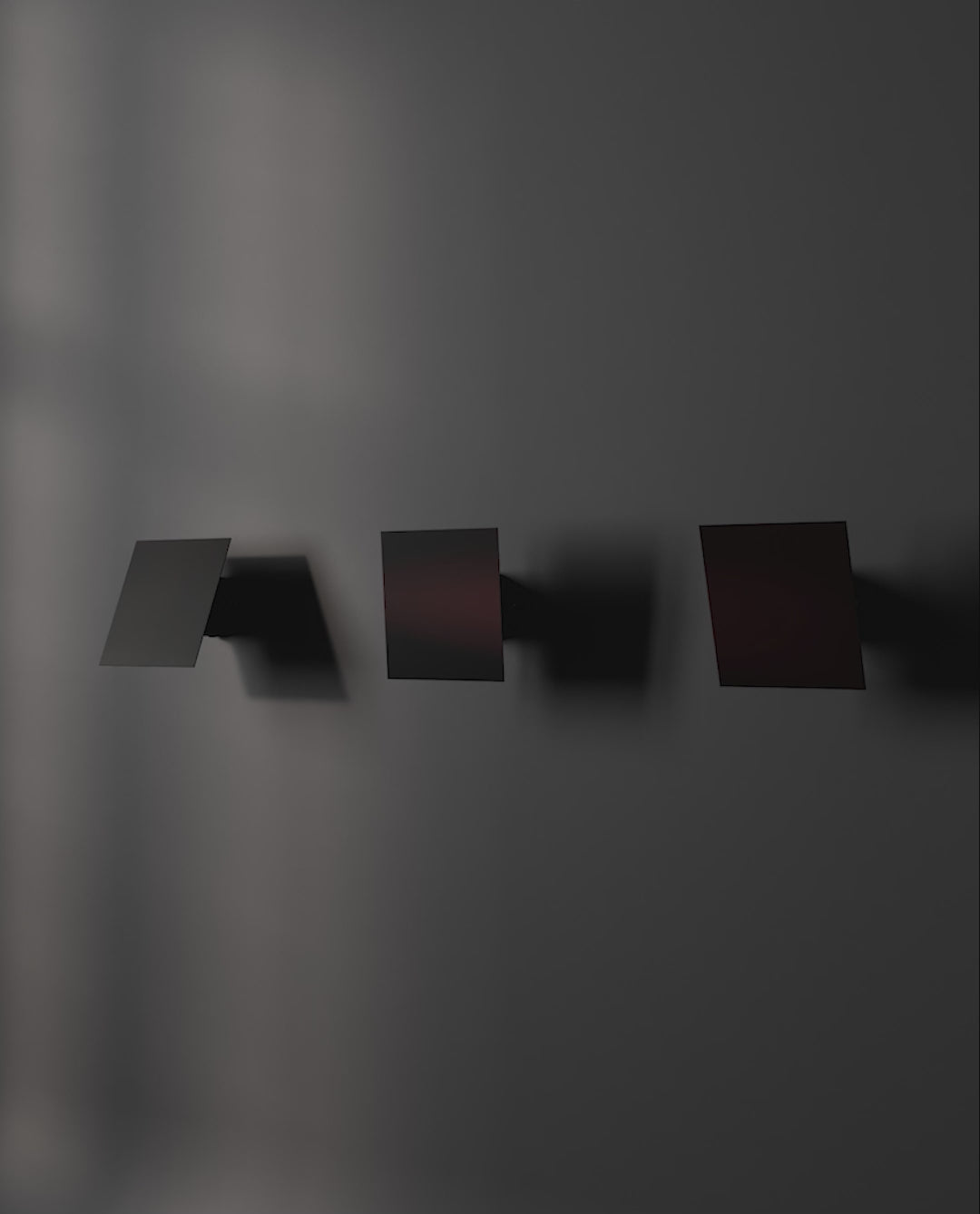 3 directions of Chameleon Wall lamp in Burned black, lit and off.